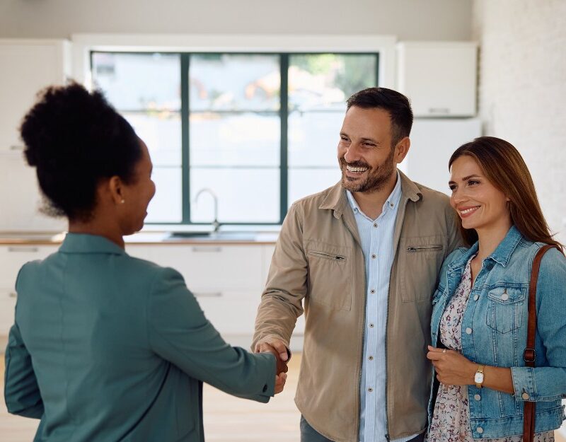 Couple talking to a broker to buy a house
