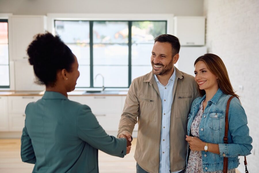 Couple talking to a broker to buy a house